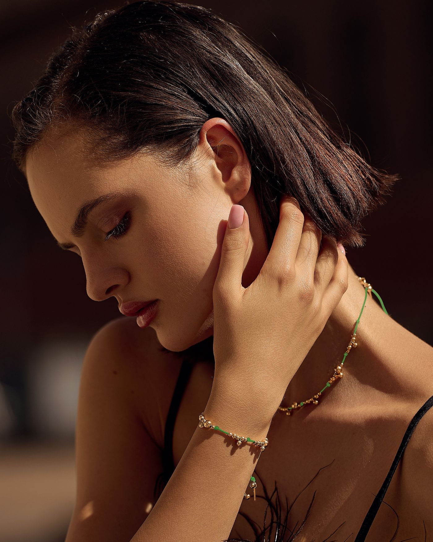 Bracelet on green cord with gold-gilded beads  - 1