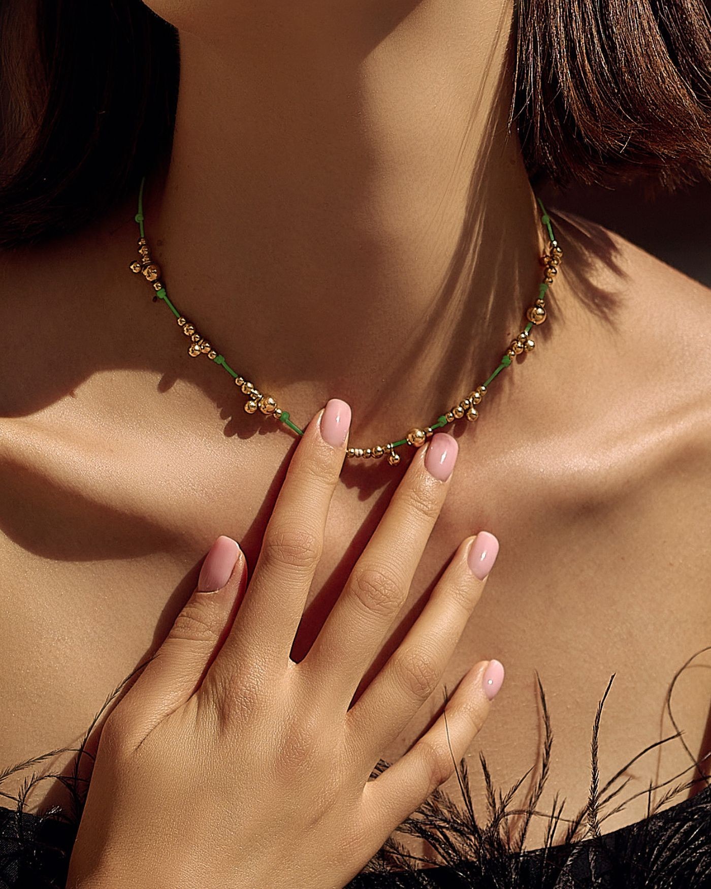 Necklace on green cord with gold-gilded beads  - 1